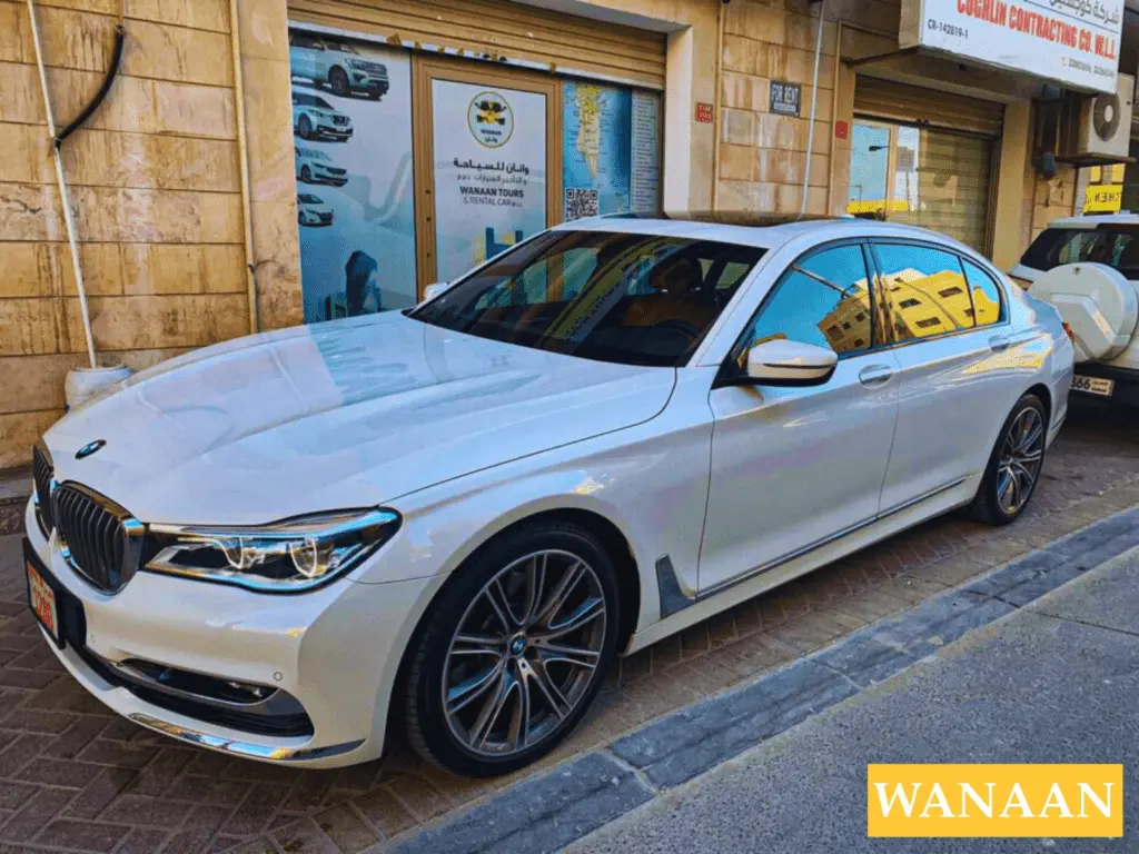 Luxury Car Rentals in Juffair & Manama – Wanaan 3 White BMW 7 Series luxury sedan parked outside the Wanaan car rental office
